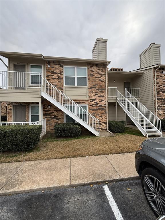 2200 East Trinity Mills Road, Unit 208 Carrollton, TX 75006 - Photo 22 of 23 a front view of a house with garage