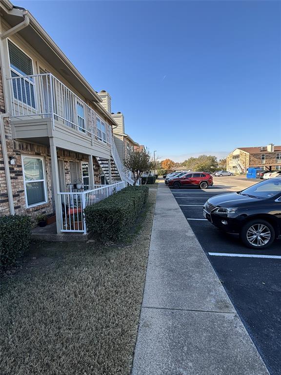 2200 East Trinity Mills Road, Unit 208 Carrollton, TX 75006 - Photo 8 of 23 a view of a car park in front of house