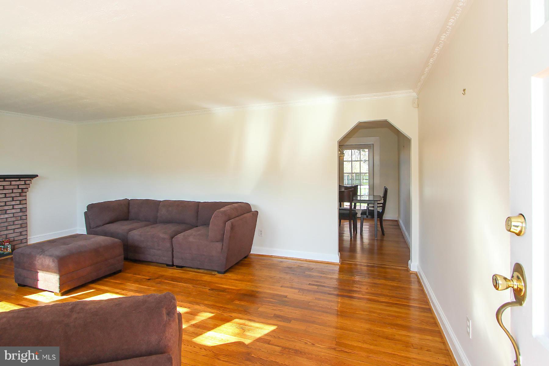20820 Slidell Road Boyds, MD 20841 - Photo 3 of 29 a living room with furniture and a dining table with wooden floor