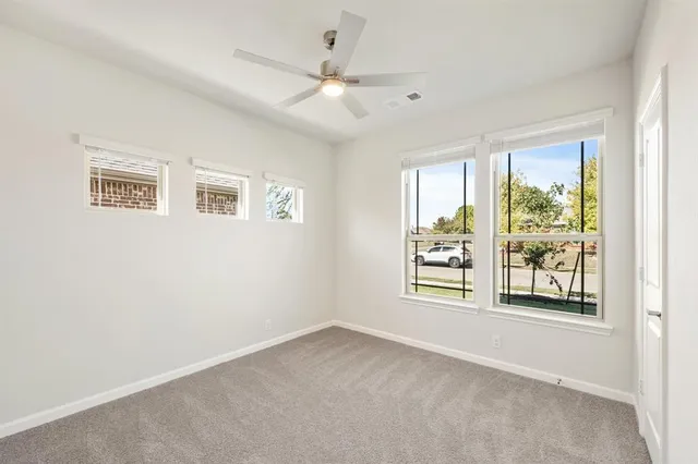 a large kitchen with kitchen island a large counter top stainless steel appliances and cabinets