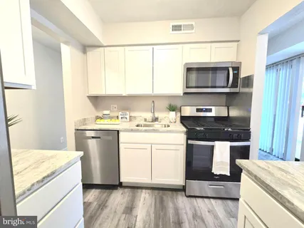 a kitchen with a refrigerator stove and sink