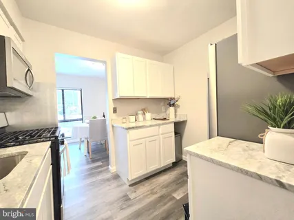 a kitchen with a sink cabinets and a window