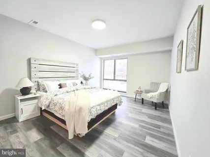 a spacious bedroom with a bed and windows