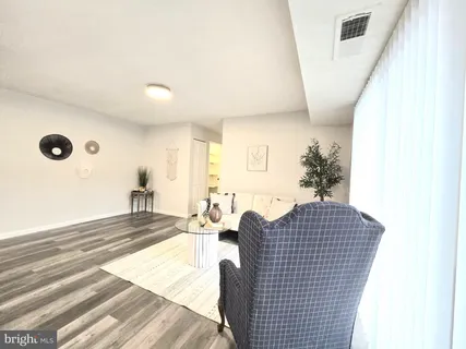 a view of a room with wooden floor and a window