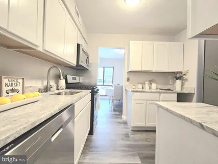 a kitchen with a sink stove and microwave