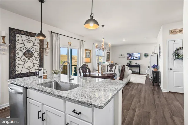 a kitchen with sink stove and wooden floor