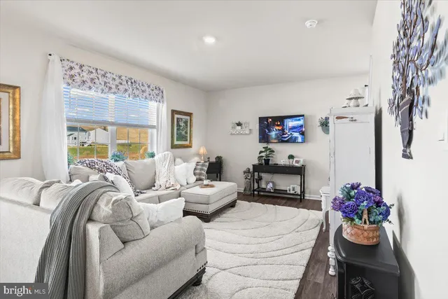 a bedroom with furniture and a large window