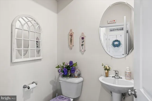 a bathroom with a sink mirror and toilet