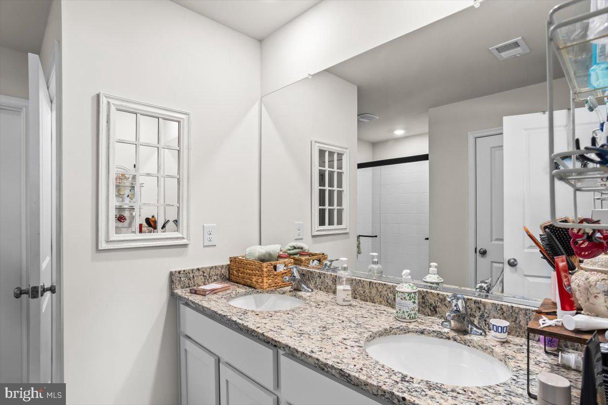 4310 Brent Dr Spring Grove Spring Grove, PA 17362 - Photo 24 of 36 a bathroom with a granite countertop sink a mirror and a window