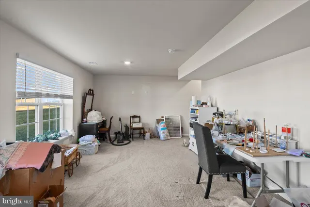 a dining room with furniture and a floor to ceiling window