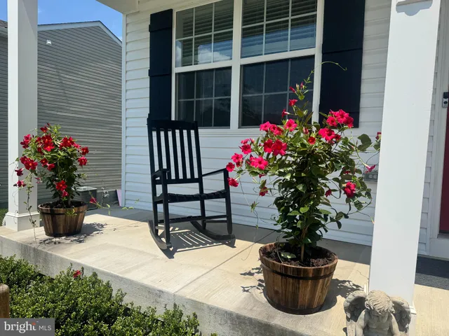 a flower garden is sitting in front of house