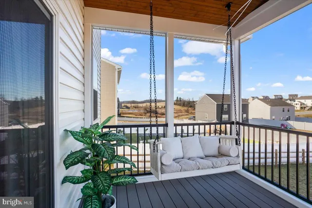 a view of a balcony with floor to ceiling windows with wooden floor