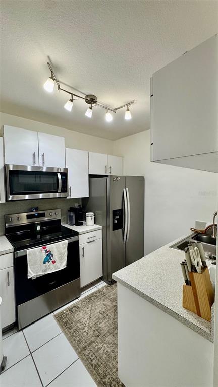 7111 Southwest 129th Avenue, Unit 1 Miami, FL 33183 - Photo 12 of 16 a kitchen with stainless steel appliances granite countertop a refrigerator and a stove