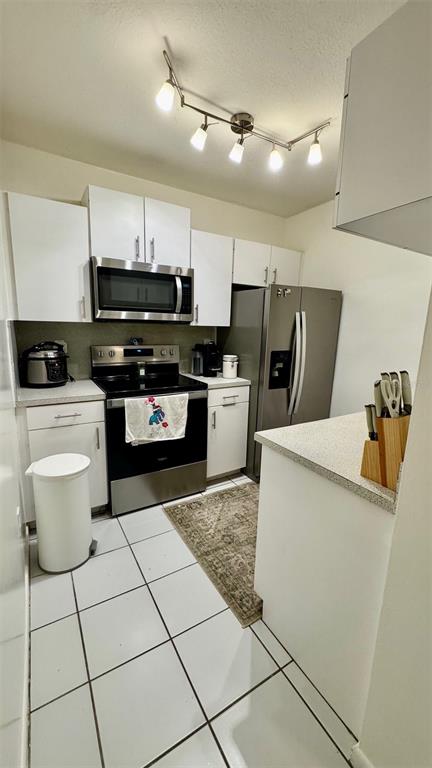 7111 Southwest 129th Avenue, Unit 1 Miami, FL 33183 - Photo 13 of 16 a kitchen with a sink a stove and cabinets