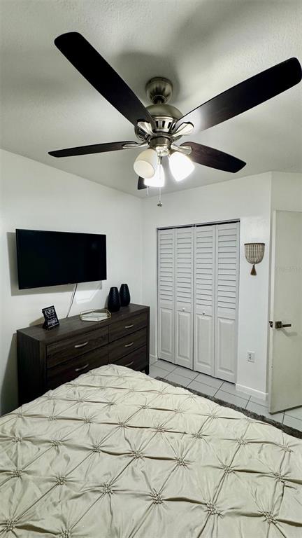 7111 Southwest 129th Avenue, Unit 1 Miami, FL 33183 - Photo 15 of 16 a bedroom with a bed and a flat tv screen on the dresser