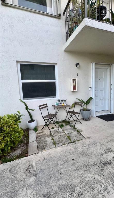 7111 Southwest 129th Avenue, Unit 1 Miami, FL 33183 - Photo 2 of 16 a backyard of a house with table and chairs