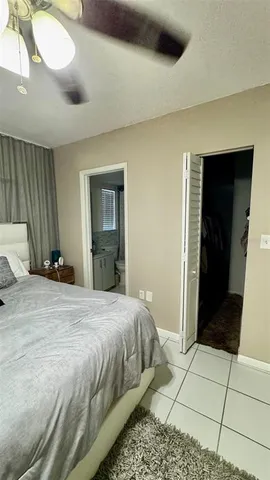 a bedroom with a bed and a mirror