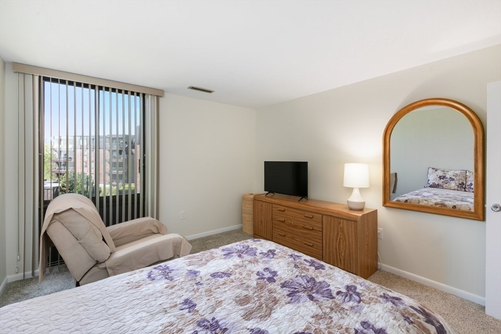 1008 Paradise Road, Unit 2E Swampscott, MA 01907 - Photo 13 of 22 a bedroom with a bed and a television