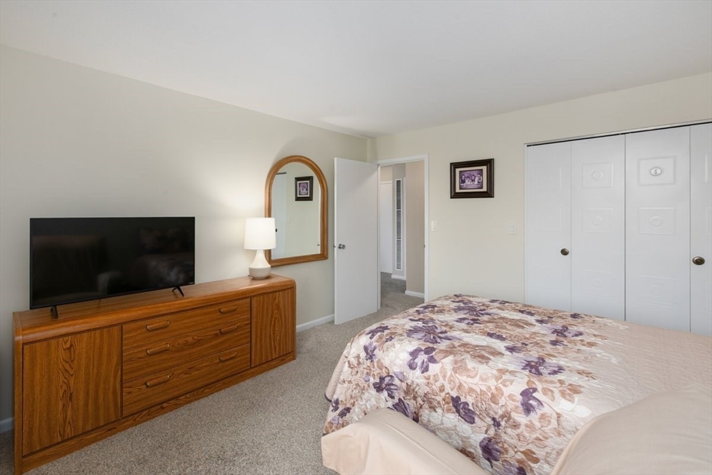 1008 Paradise Road, Unit 2E Swampscott, MA 01907 - Photo 14 of 22 a bedroom with a bed and a flat screen tv