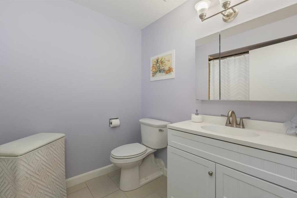 1008 Paradise Road, Unit 2E Swampscott, MA 01907 - Photo 16 of 22 a bathroom with a toilet sink and mirror