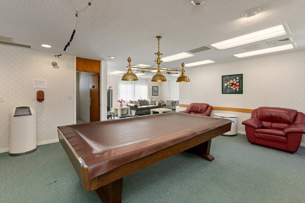 1008 Paradise Road, Unit 2E Swampscott, MA 01907 - Photo 19 of 22 a living room with furniture and a chandelier