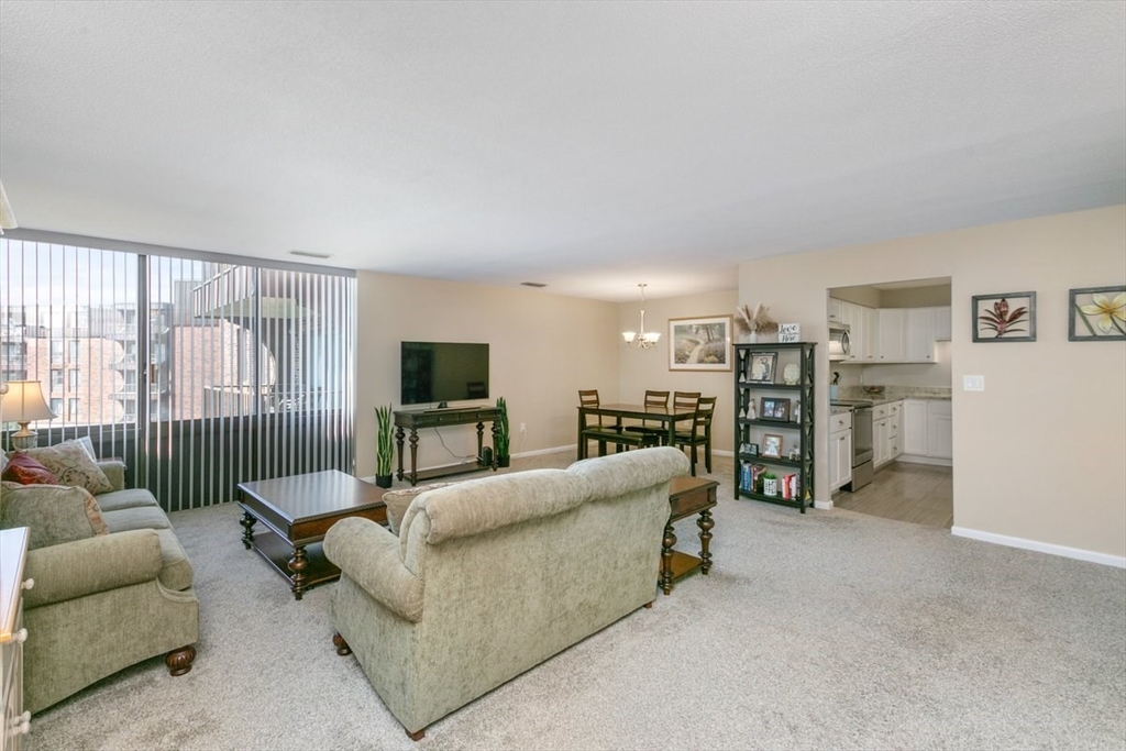 1008 Paradise Road, Unit 2E Swampscott, MA 01907 - Photo 5 of 22 a living room with furniture and a flat screen tv
