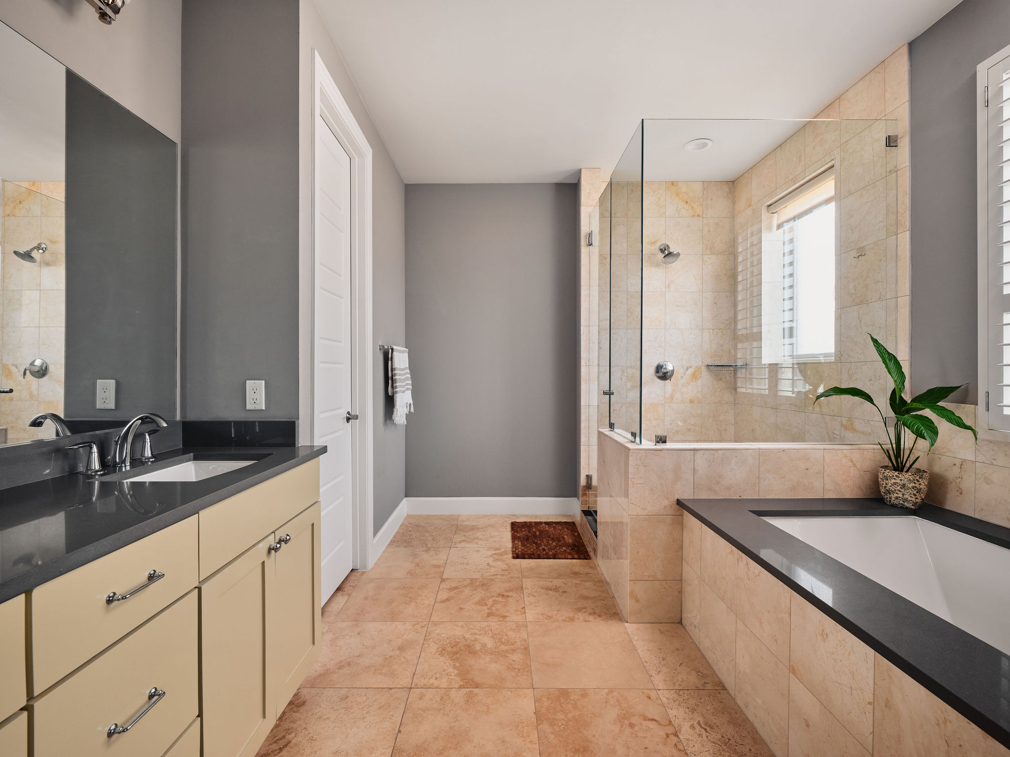 1504 Collier Street, Unit 4 Austin, TX 78704 - Photo 17 of 38 Full bathroom with vanity, a shower stall, a garden tub, and light tile patterned floors