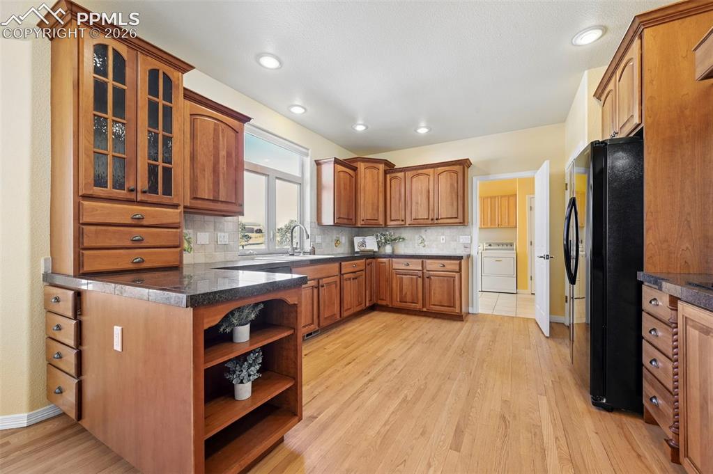 19610 Rathbone Circle Monument, CO 80132 - Photo 14 of 41 a kitchen with stainless steel appliances granite countertop a refrigerator a stove and a wooden floors