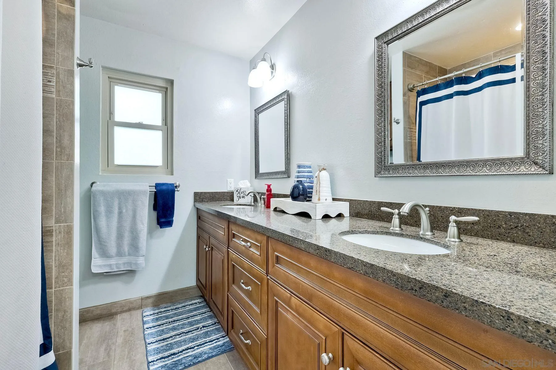 1915 Rockhoff Road Escondido, CA 92026 - Photo 25 of 43 a bathroom with double vanity sinks and a mirror