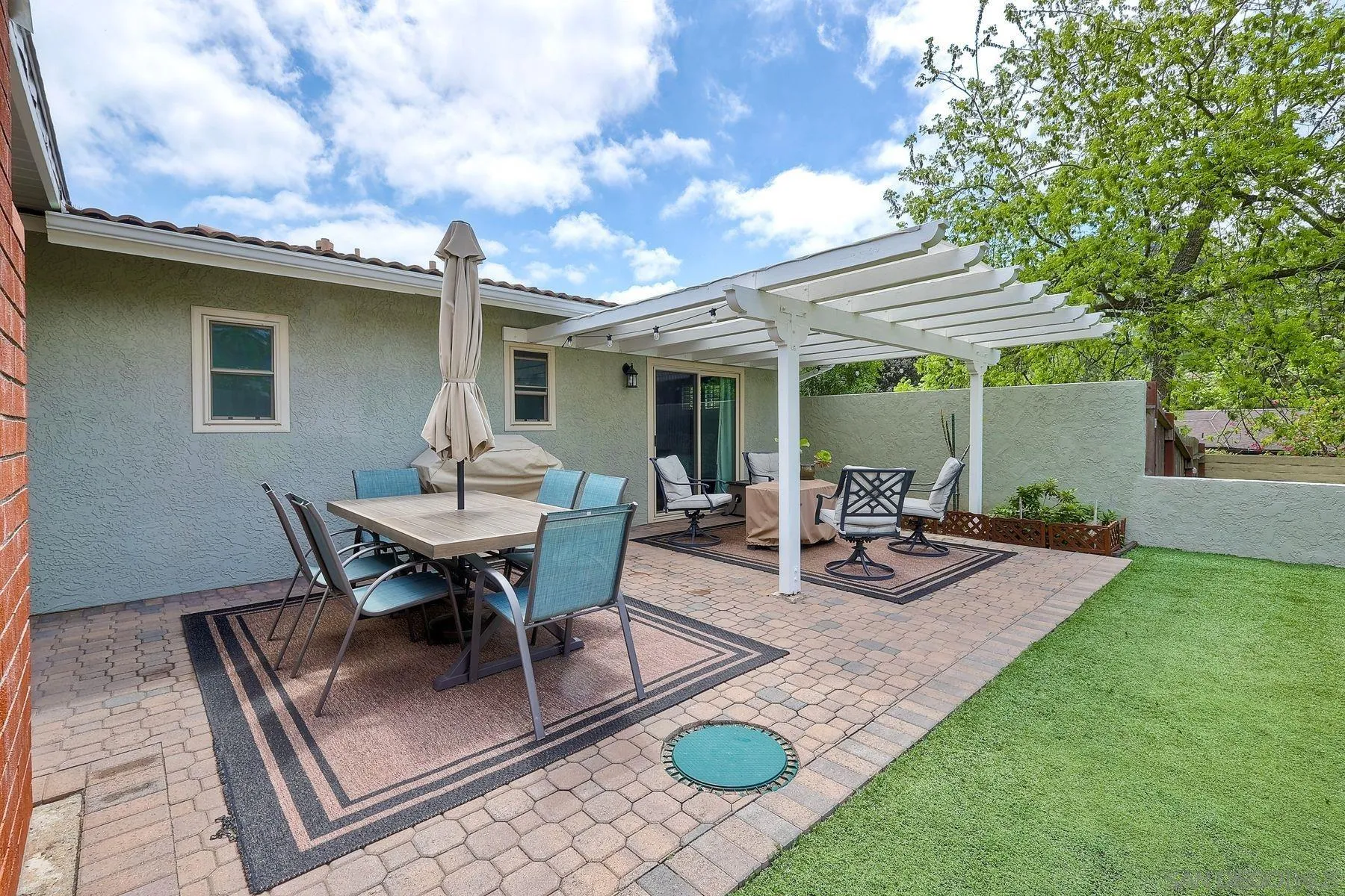 1915 Rockhoff Road Escondido, CA 92026 - Photo 26 of 43 a view of a patio with table and chairs with wooden floor and fence