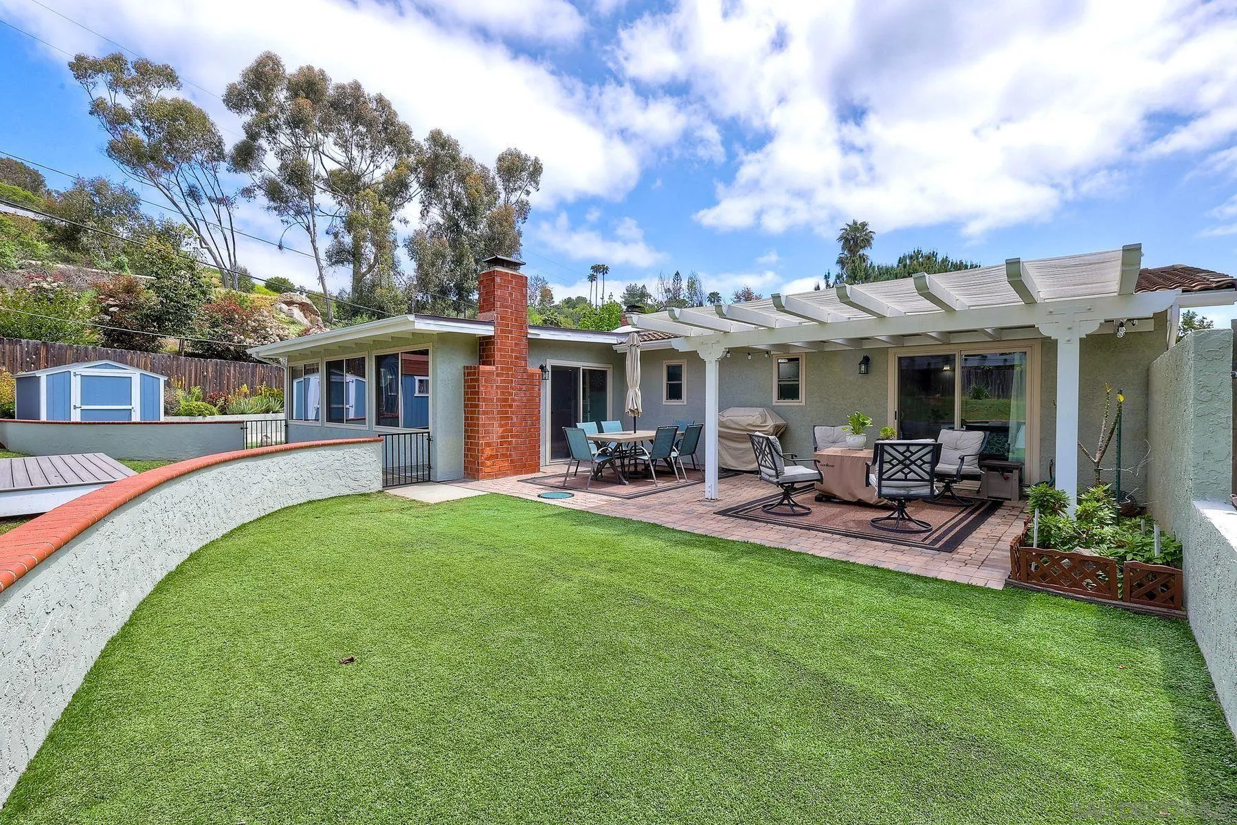 1915 Rockhoff Road Escondido, CA 92026 - Photo 28 of 43 a view of a house with a yard porch and sitting area