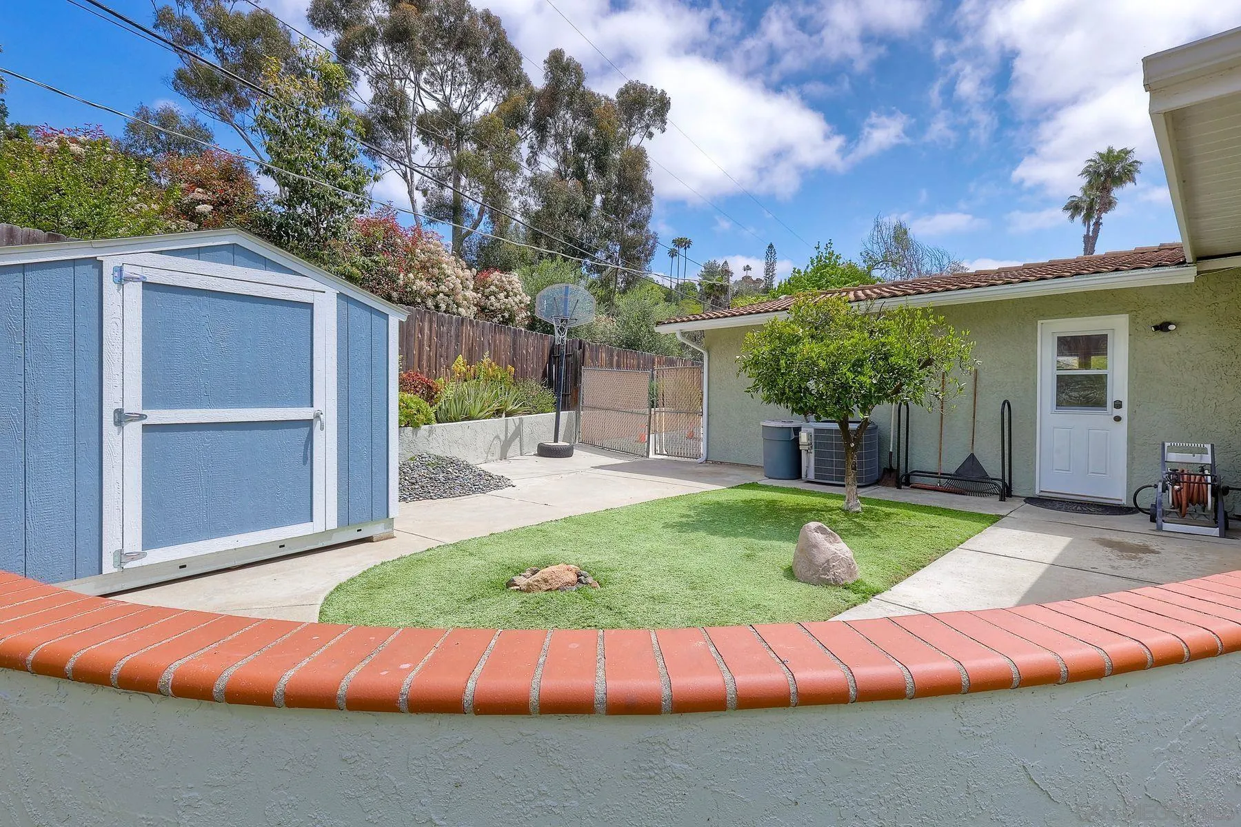 1915 Rockhoff Road Escondido, CA 92026 - Photo 33 of 43 a view of a backyard with couches plants and large trees