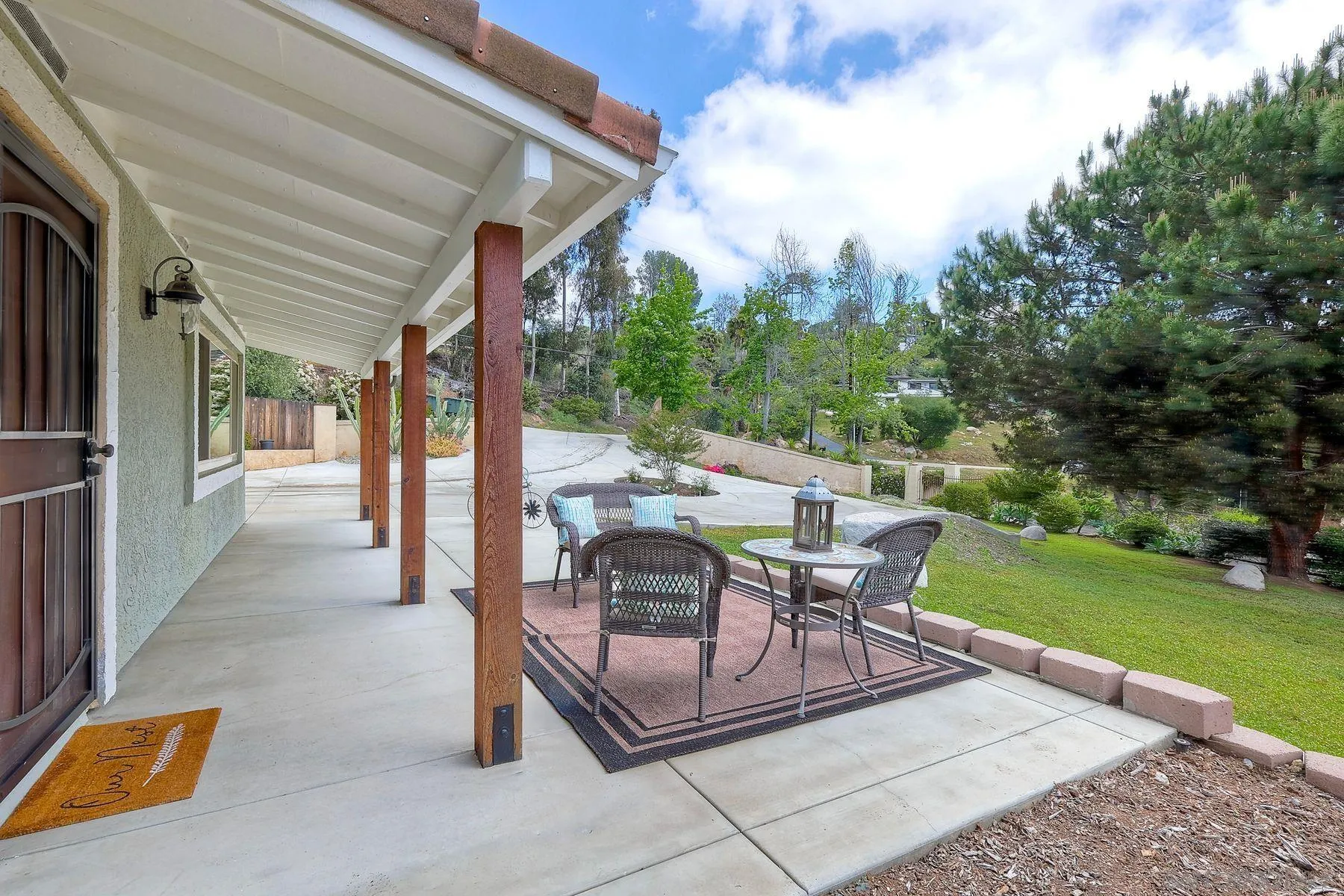 1915 Rockhoff Road Escondido, CA 92026 - Photo 35 of 43 a view of a patio with a table chairs and a yard
