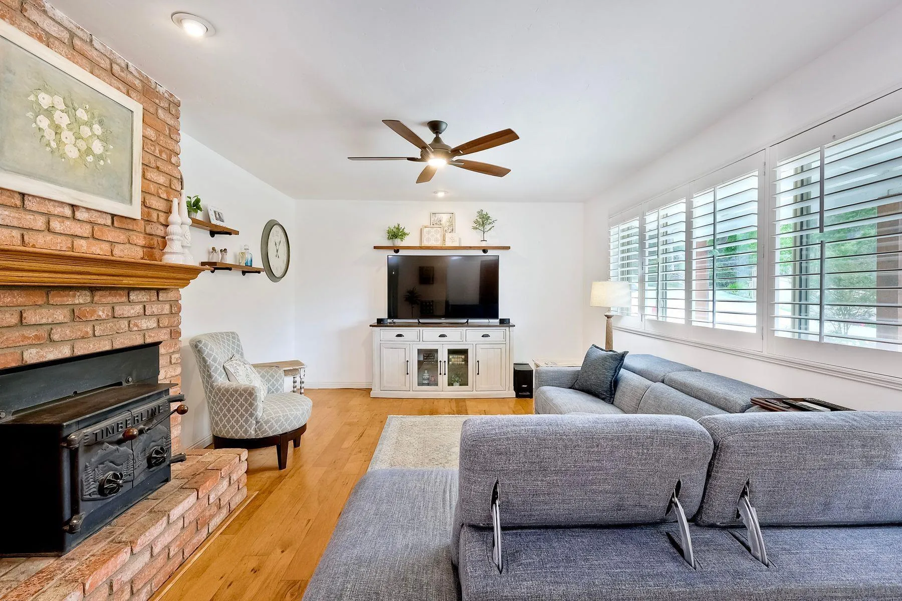 1915 Rockhoff Road Escondido, CA 92026 - Photo 5 of 43 a living room with furniture a flat screen tv and a fireplace