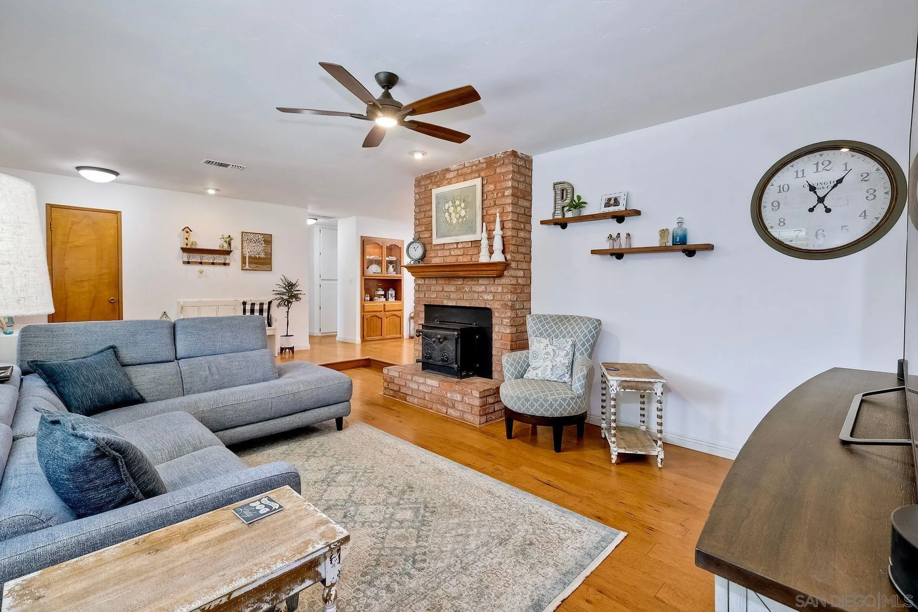 1915 Rockhoff Road Escondido, CA 92026 - Photo 9 of 43 a living room with furniture a clock and a fireplace