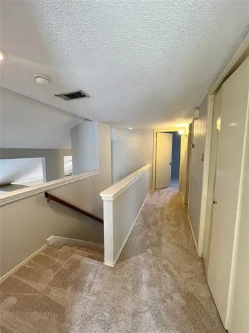 a view of a room with a ceiling fan and a window