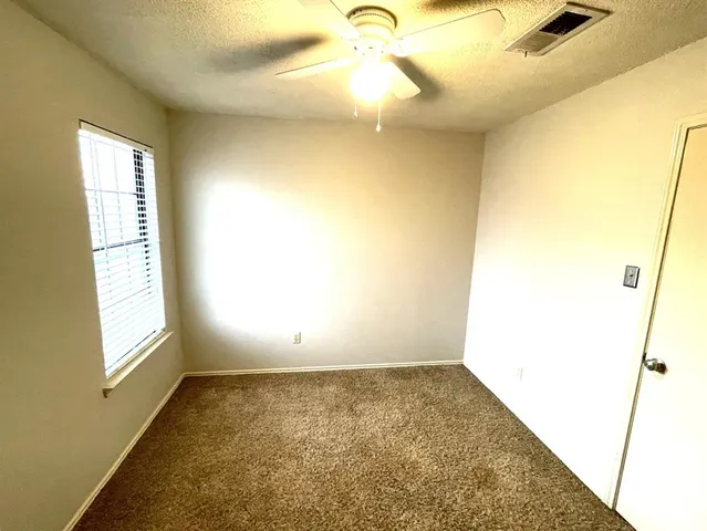 a bathroom with a granite countertop toilet sink and mirror