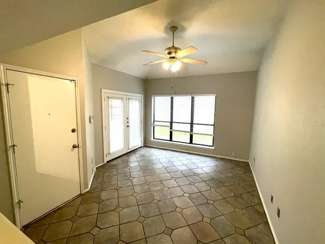 an empty room with a kitchen and a sink