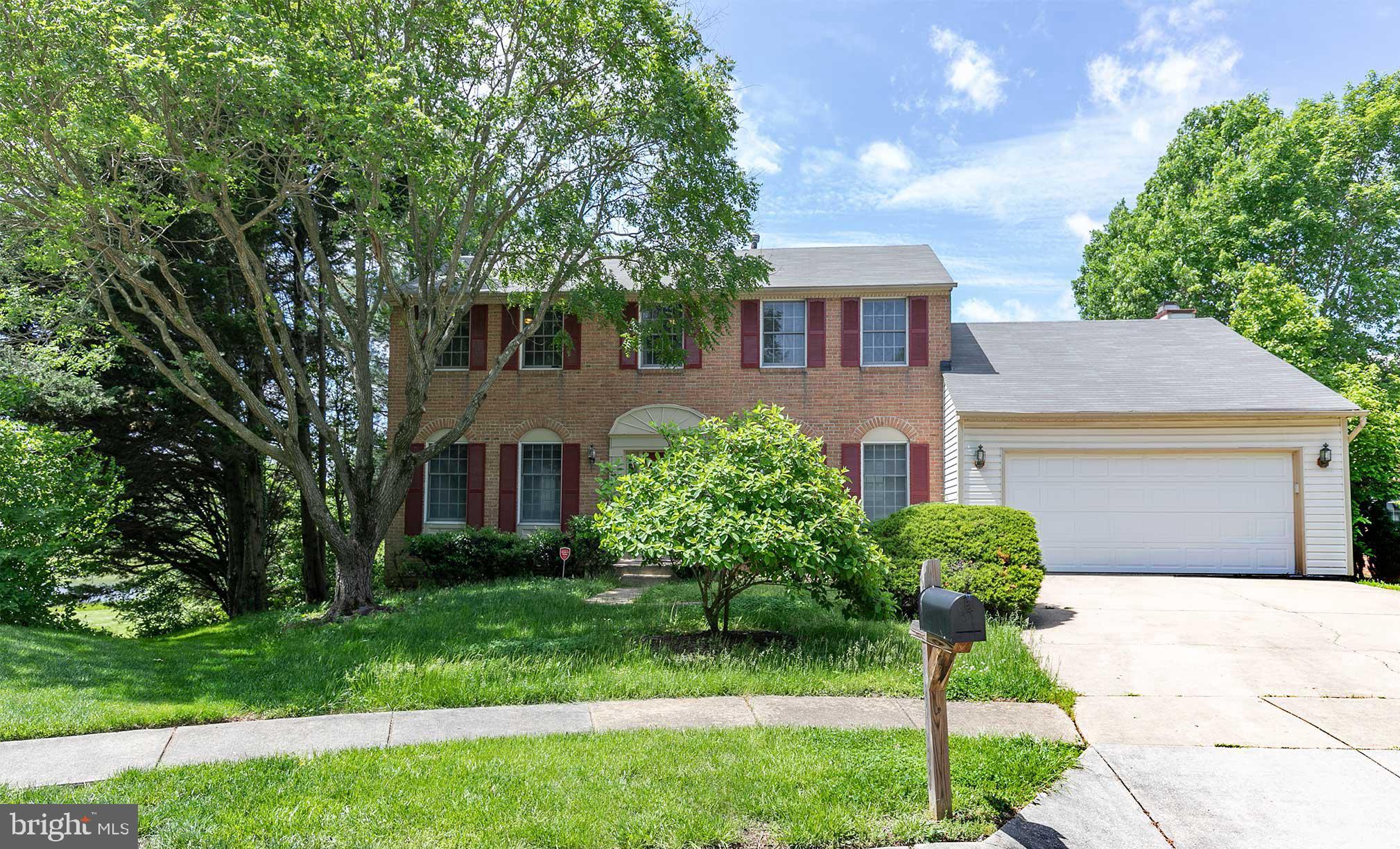 10801 Golf Course Court Bowie, MD 20721 - Photo 1 of 52 a front view of a house with a garden and plants