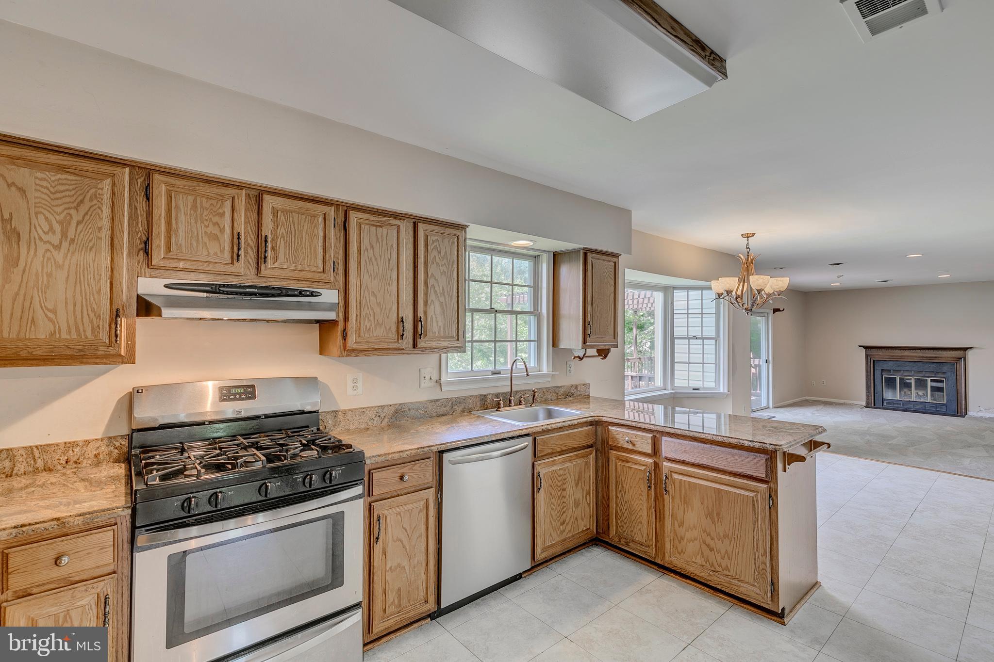 10801 Golf Course Court Bowie, MD 20721 - Photo 12 of 52 a kitchen with granite countertop stainless steel appliances a sink stove and cabinets