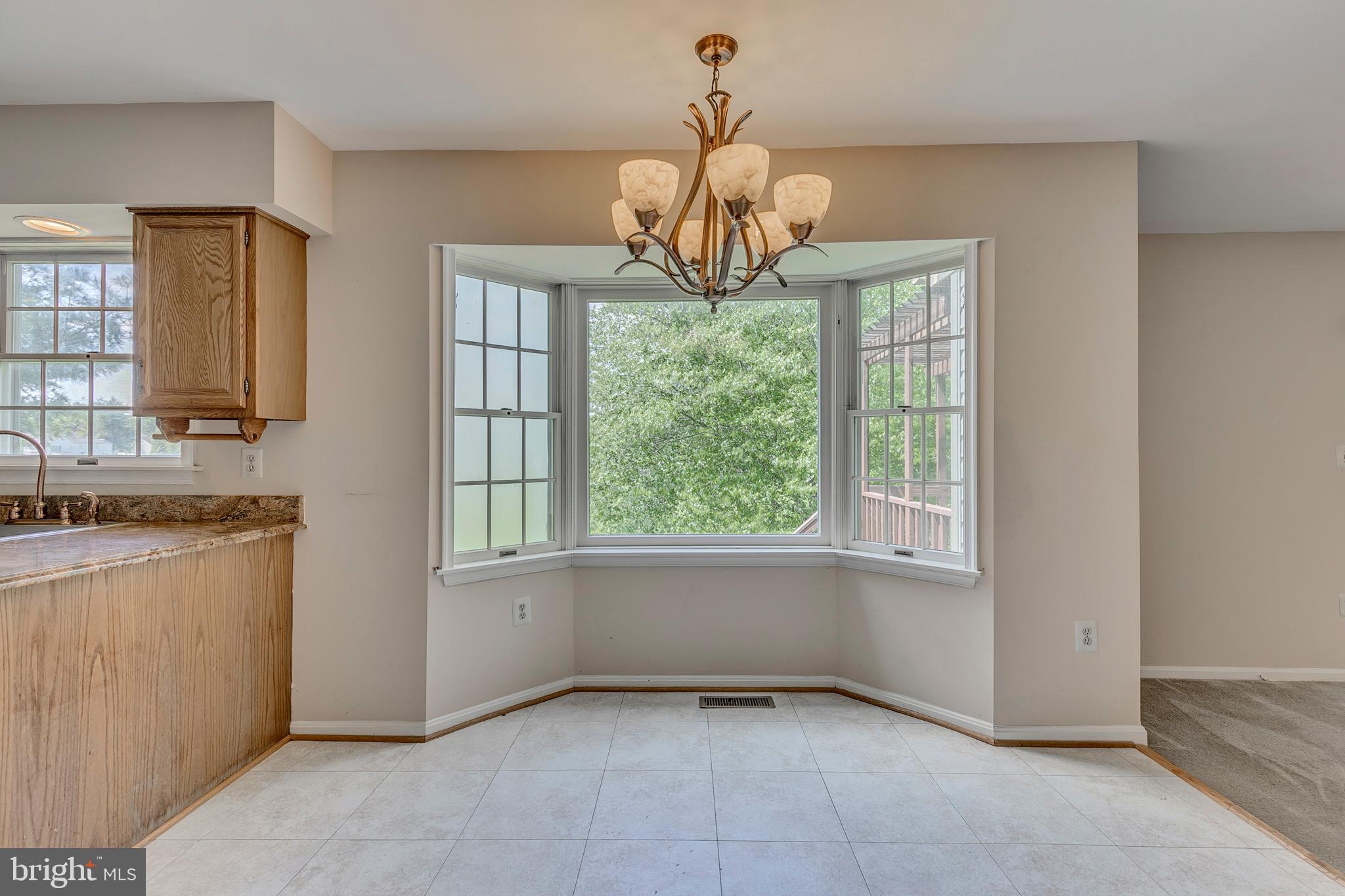 10801 Golf Course Court Bowie, MD 20721 - Photo 14 of 52 a dining room with chandelier and windows