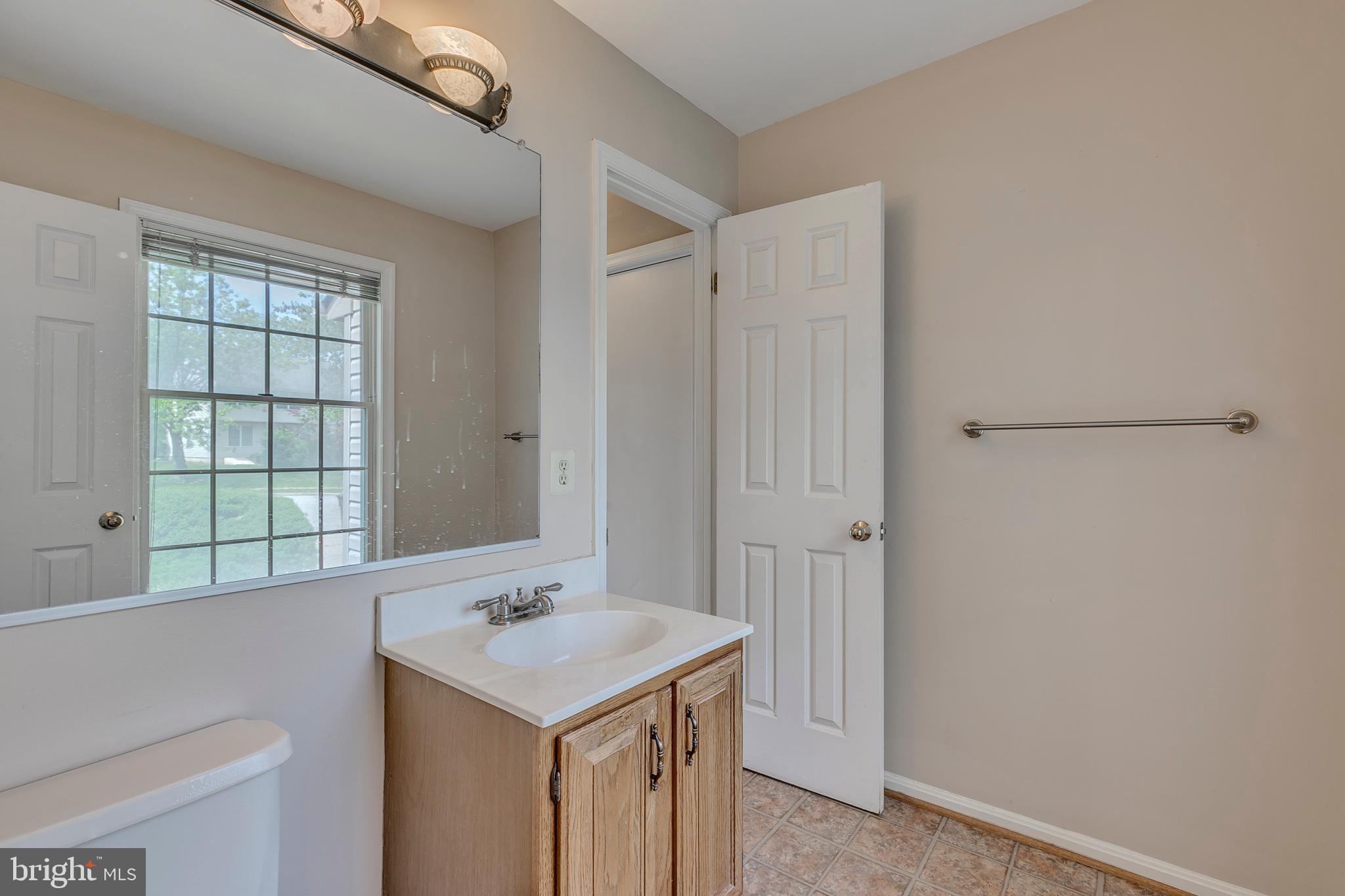 10801 Golf Course Court Bowie, MD 20721 - Photo 18 of 52 a bathroom with a sink a toilet and a shower