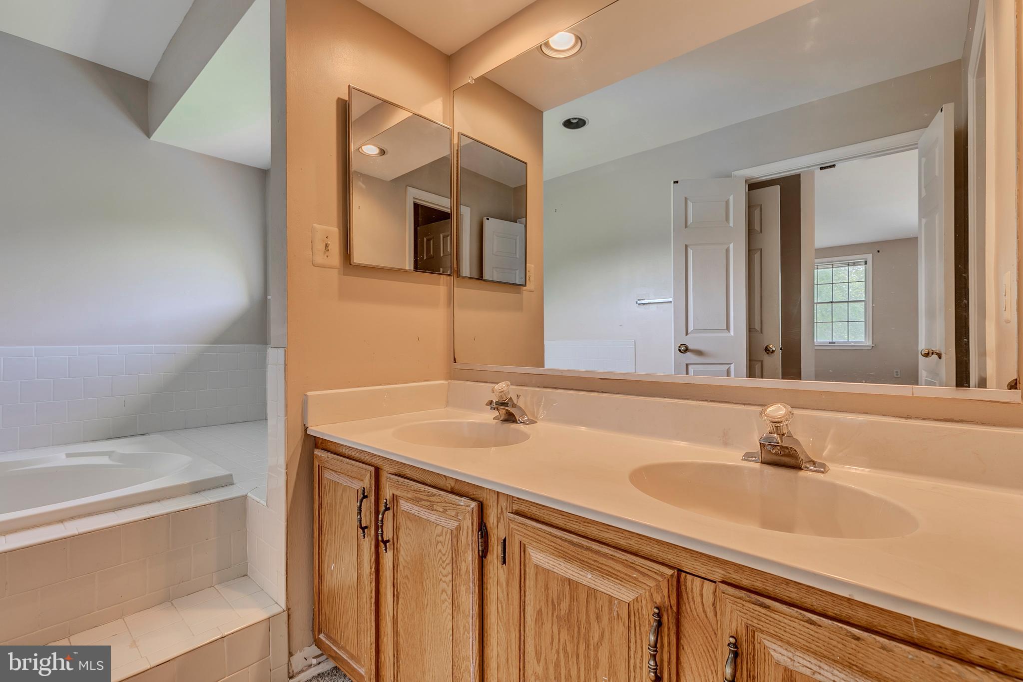 10801 Golf Course Court Bowie, MD 20721 - Photo 22 of 52 a bathroom with a sink and a mirror