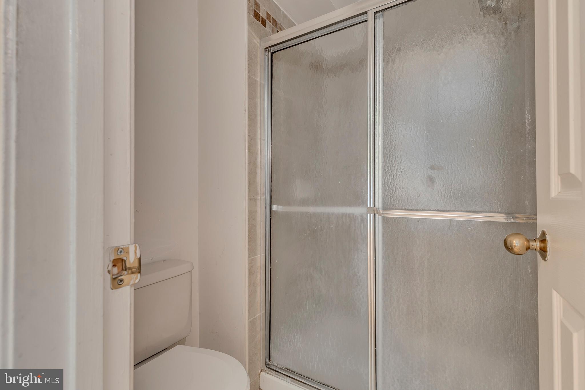 10801 Golf Course Court Bowie, MD 20721 - Photo 24 of 52 a bathroom that has a glass shower door
