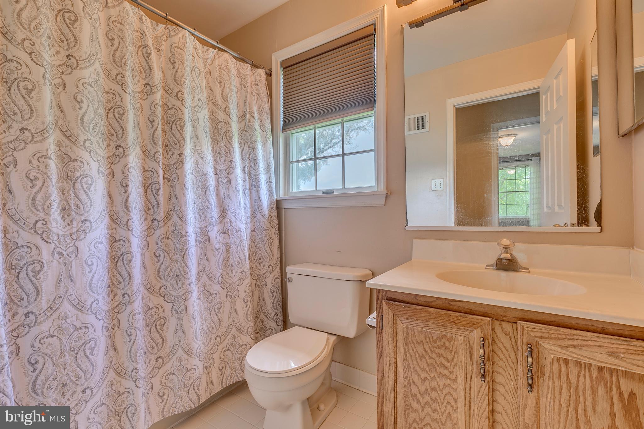 10801 Golf Course Court Bowie, MD 20721 - Photo 28 of 52 a bathroom with a sink toilet and shower