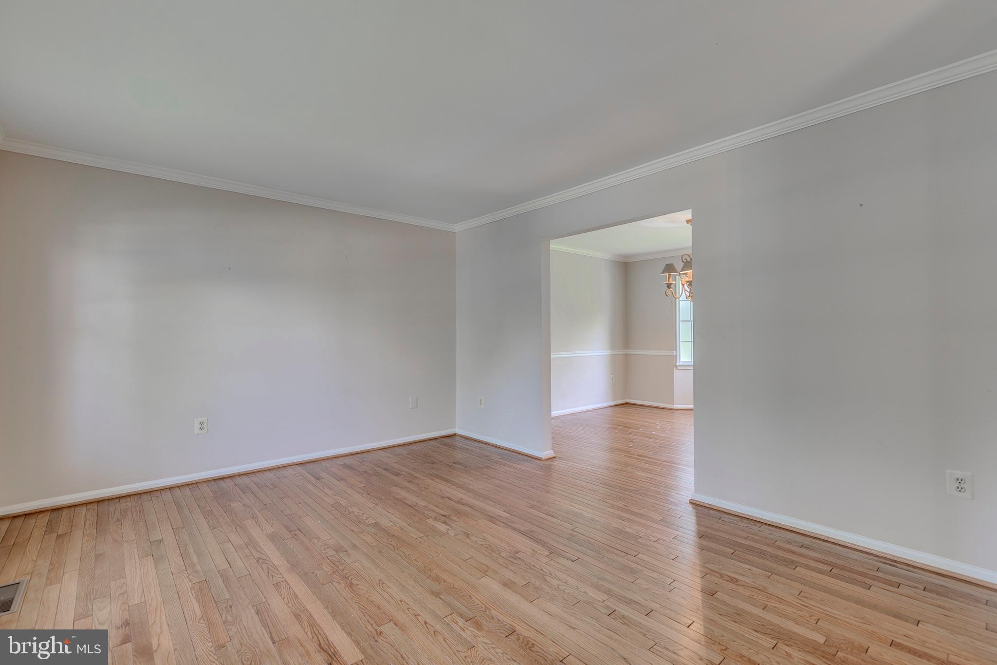 10801 Golf Course Court Bowie, MD 20721 - Photo 7 of 52 a view of an empty room with wooden floor and a window