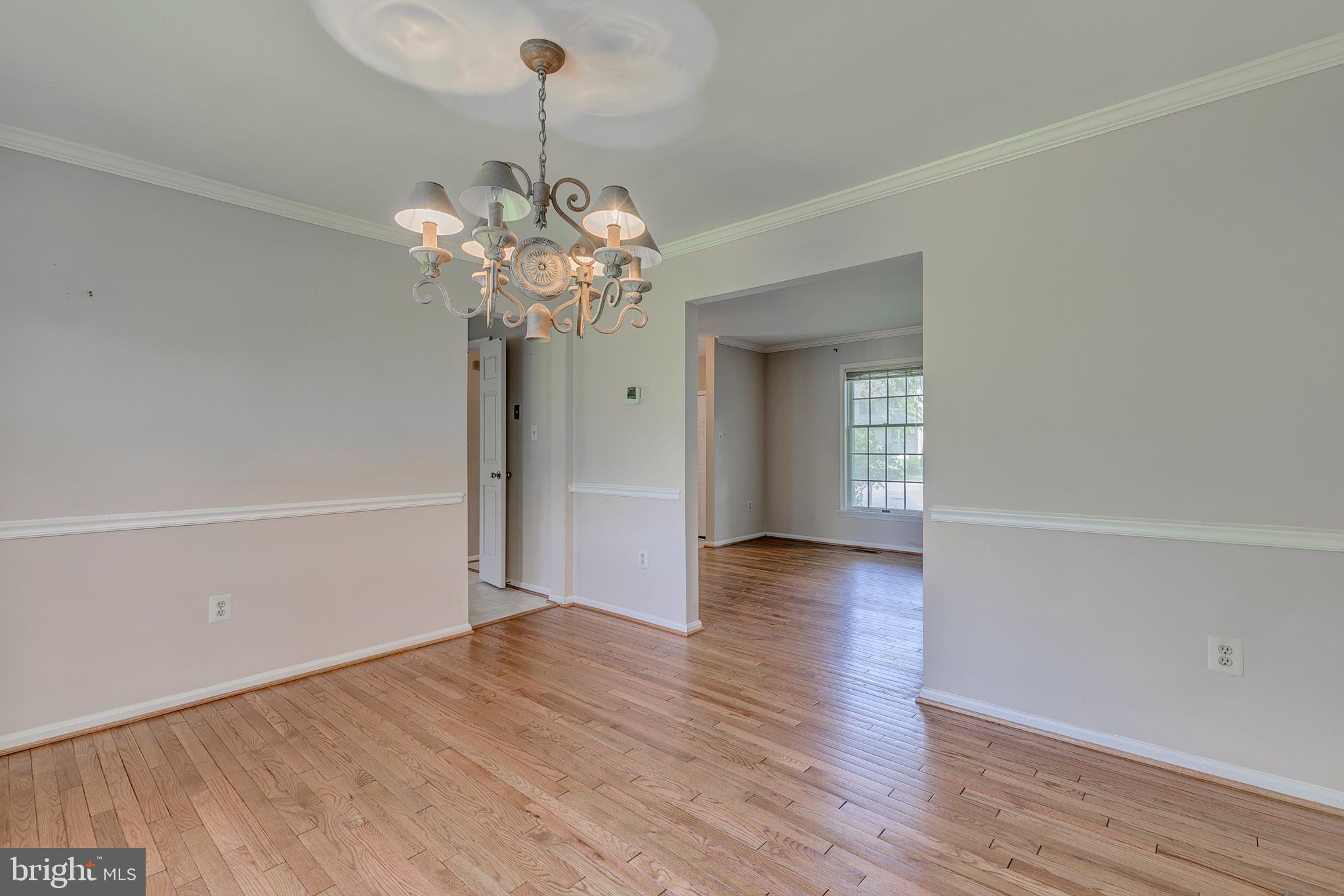 10801 Golf Course Court Bowie, MD 20721 - Photo 10 of 52 a view of a room with wooden floor and chandelier