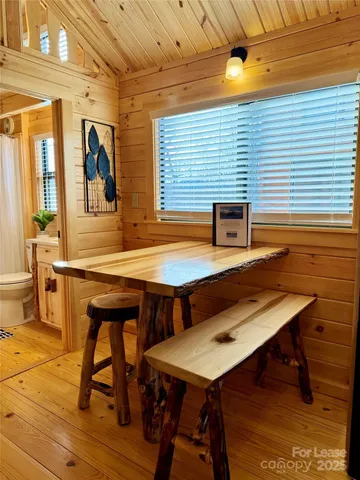 a view of a patio with table and chairs with wooden floor and fence