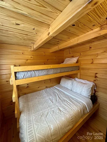 a bed sitting in a bedroom next to a window