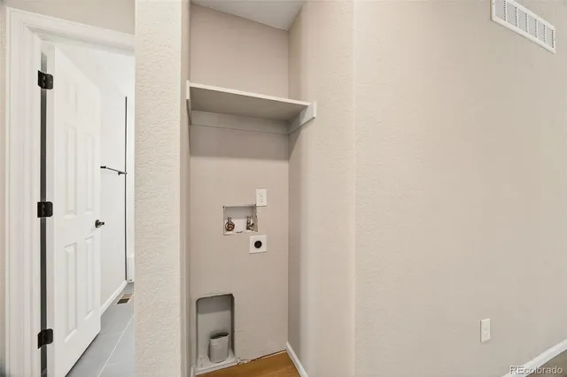 a view of a patio with table and chairs with wooden floor and fence
